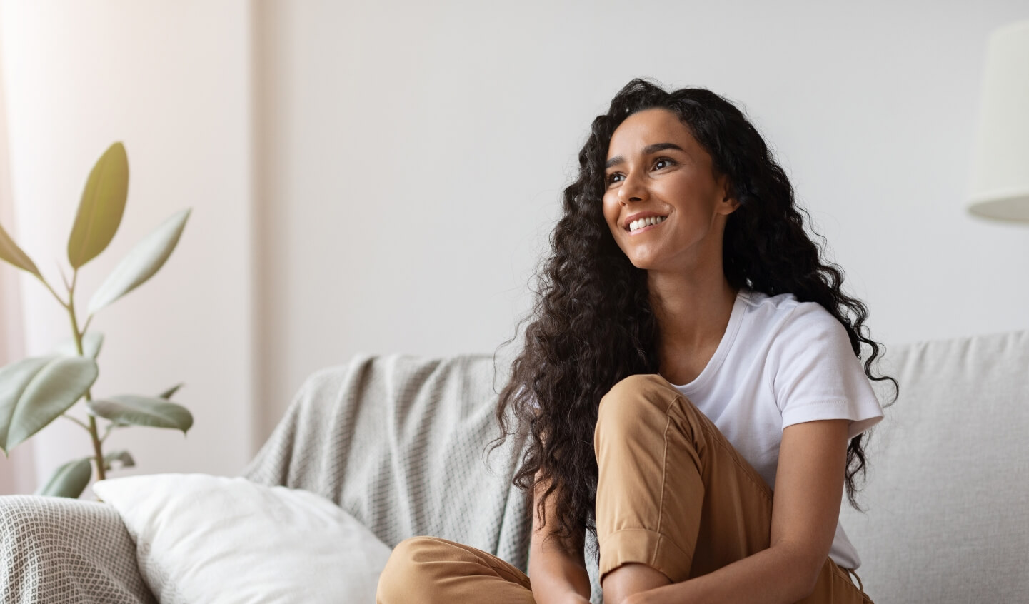 Nutritional coaching client relaxes on couch