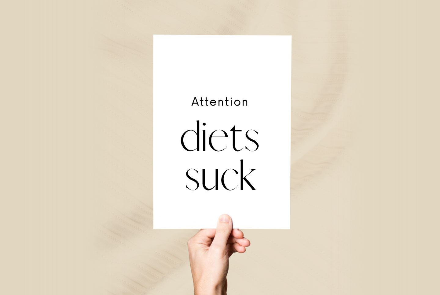 Hand holding up a sign - Attention Diets Suck