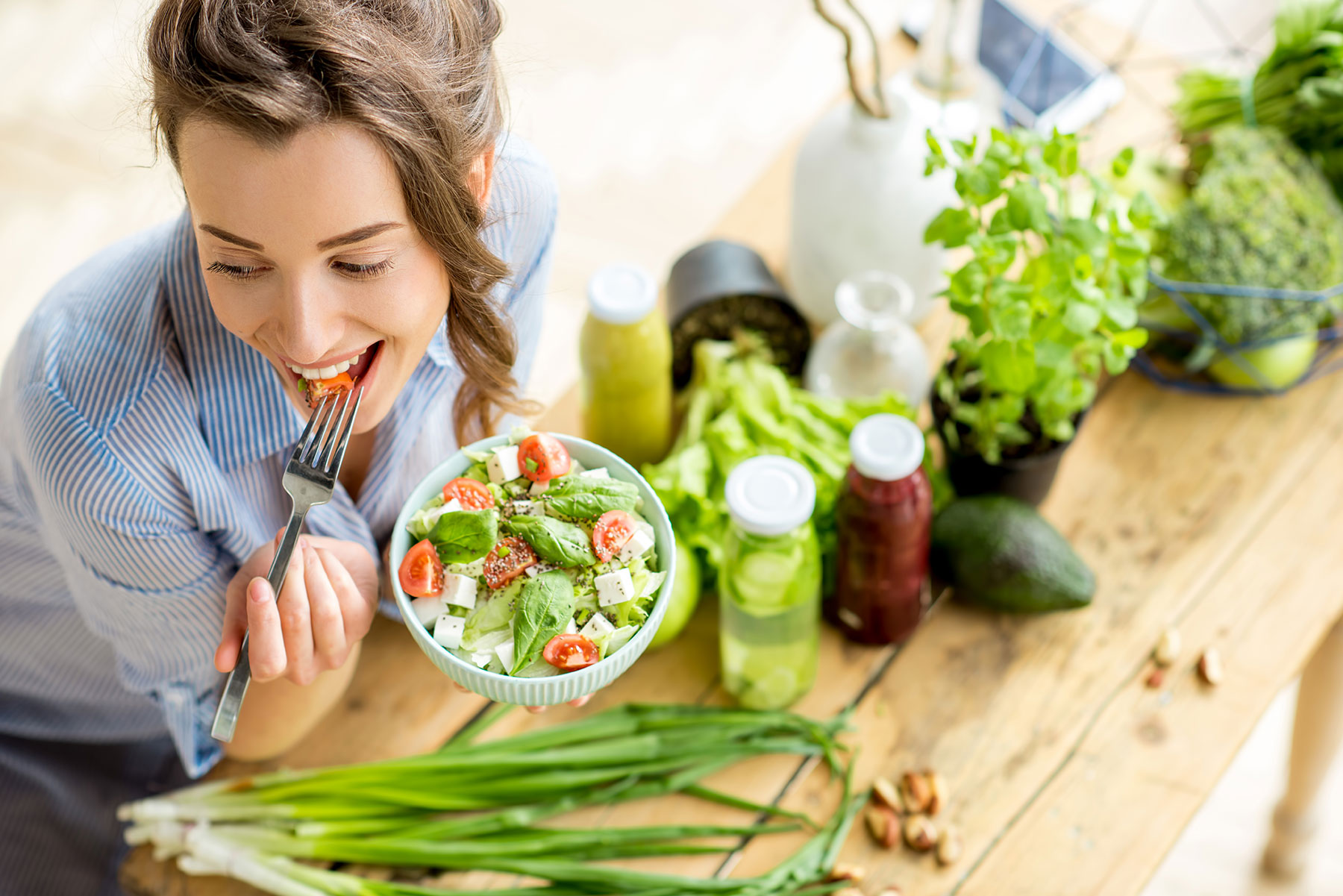 Healthy young woman fueling her body with green salad